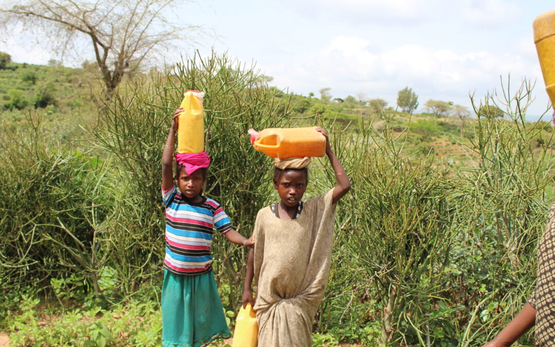girls carrying water